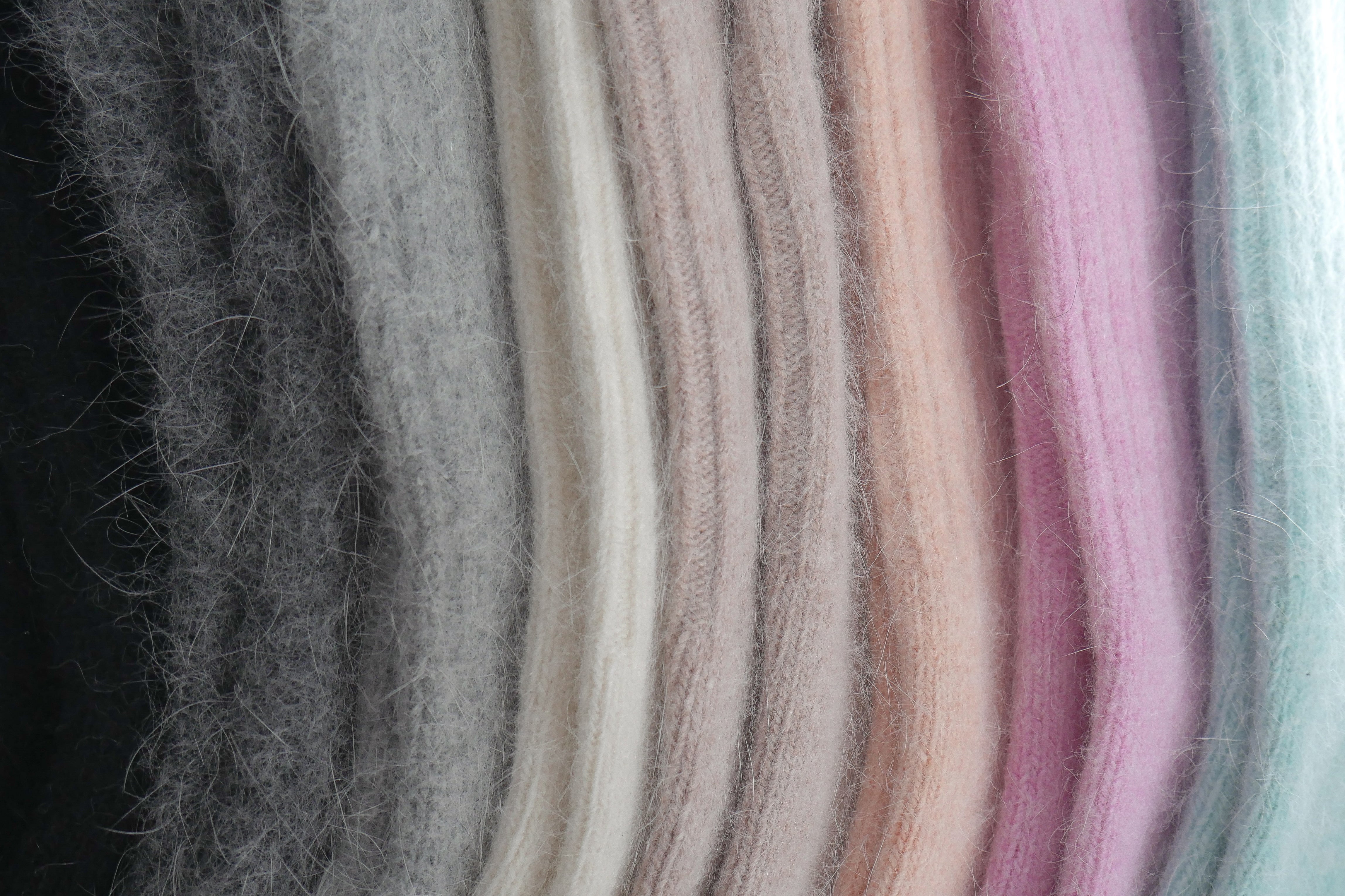Close-up of ELMNTL soft wool winter socks in a row of pastel and neutral colors